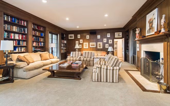 Không gian thư viện ấm cúng, kín đáo, yên tĩnh với những bức tường ốp gỗ, bộ sofa cỡ lớn và kệ sách âm tường khổng lồ.