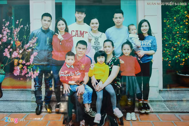 Tết Nguyên đán năm ngoái, Mạnh "gắt" đã đưa bạn gái về nhà chơi và chụp ảnh kỷ niệm. Đôi trẻ đứng cạnh nhau tình cảm ở giữa bức hình, ngay sau bố mẹ nam hậu vệ. Ảnh: Kiệt Trần, Việt Hùng.