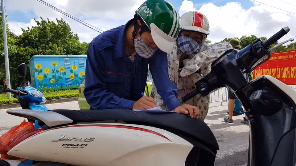 Một số người dân phải khai báo y tế trên yên xe.