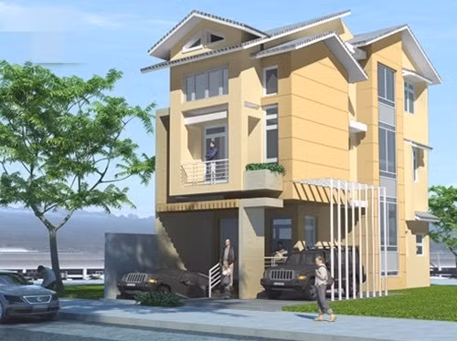 Nhà 3 tầng mái kép nổi bật với màu sơn vàng nhạt chủ đạo, có gara để xe rộng rãi. Ảnh: Dulux.