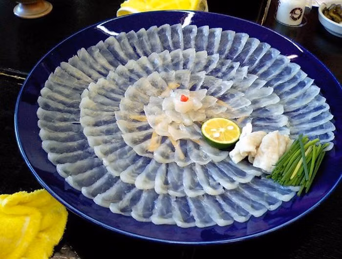 Fugu được biết đến là một món ăn làm từ cá nóc – một loài cá có chứa độc tố. Fugu ăn kèm với những gia vị như nước chấm làm từ dầu mè, nước tương, wasabi, củ cải muối, giấm ponzu, chanh, ớt và phải có rượu nồng sake hâm nóng để bớt đi vị tanh. Được biết, chỉ có một số nhà hàng ở Tokyo được cấp giấy chứng nhận đủ tiêu chuẩn chế biến món cá cực độc này, bởi tính mạng khách hàng có thể gặp nguy hiểm nếu túi chất độc trong bụng cá bị vỡ hoặc cá bị hỏng.