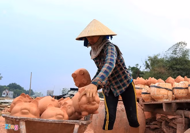 Một người thợ làm việc ở lò gốm tại xã Tân Vĩnh Hiệp (thị xã Tân Uyên) đang chuyển sản phẩm vừa bỏ khuôn vào lò nung.