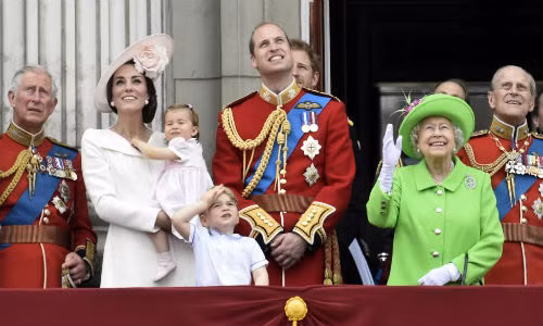 Các thành viên trong gia đình Hoàng gia Anh (từ trái sang): Thái tử Charles, Công nương Kate Middleton bế tiểu công chúa Charlotte, Hoàng tử bé George, Hoàng tử William, Nữ hoàng Anh Elizabeth II và Hoàng tế Philip đứng ở ban công cung điện Buckingham theo dõi một buổi biểu diễn sau cuộc diễu hành thường niên Trooping the Colour mừng sinh nhật lần thứ 90 của Nữ hoàng hôm 11/6.