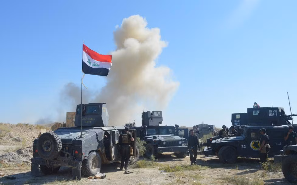 Đoàn xe quân sự của lực lượng an ninh Iraq ở thành phố Fallujah ngày 31/5.