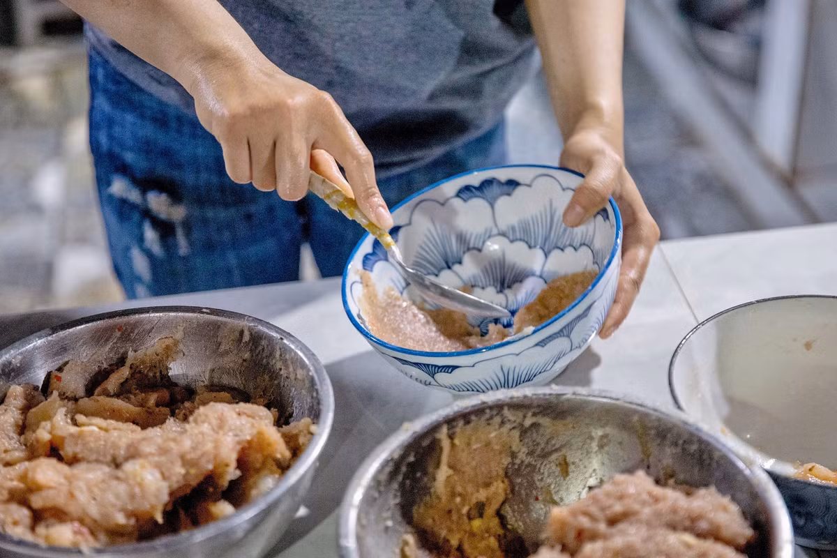 Điểm đặc biệt của món bún quậy nằm ở cách chế biến. Sau khi gọi món, thực khách sẽ được chứng kiến công đoạn làm chả ngay tại quầy. Ảnh Mai Hà Mỹ Hân