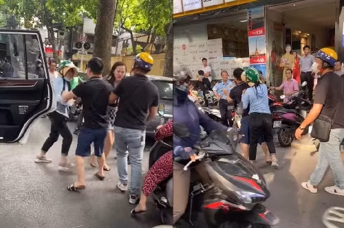 Cô gái bị cho là bồ nhí trong bộ váy đen hở hang bị người vợ đánh nhưng không thể phản kháng, chỉ khóc lóc và la hét giữa đường.
