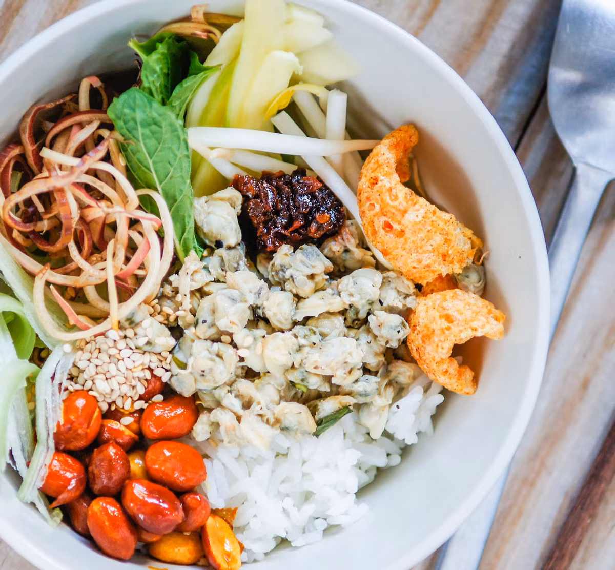 Cơm hến Huế: Cơm hến là một đặc sản ngon khó cưỡng trong ẩm thực Huế. Cơm hến được trình bày dưới hình thức là cơm nguội trộn với hến xào qua dầu và gia vị, nước hến, mắm ruốc, rau bắp cải, tóp mỡ, bánh tráng nướng, mì xào giòn, ớt màu, đậu phộng nguyên hạt, dầu ăn chín, tiêu, vị tinh (bột ngọt, mì chính) và muối. Đây là món ăn dân dã dễ tìm kiếm khi du khách đến thăm Huế. Ảnh: Anandi.