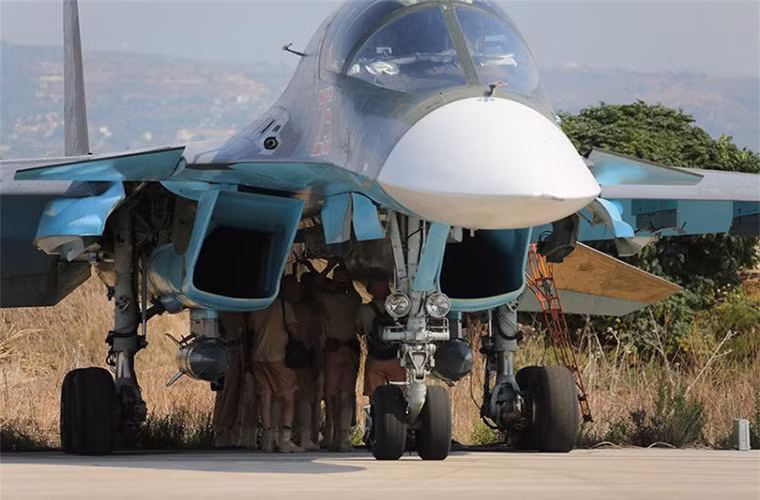 Các binh sĩ Nga túm tụm kiểm tra lần cuối các giá mang bom dẫn đường trên chiếc Su-34.