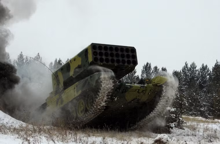 Hệ thống pháo phản lực hạng nặng TOS-1A Buratino gồm hai thành phần chính: Xe chiến đấu BM-1 trang bị giá phóng có thể xoay đổi hướng và hai xe tiếp đạn TZM-T. Ảnh: Xe chiến đấu BM-1 được thiết kế trên khung gầm xe tăng T-72A.
