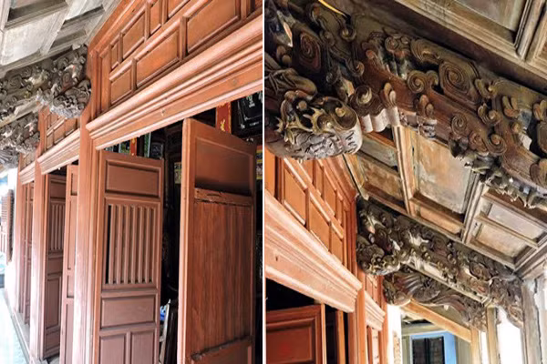 Ngôi nhà được dựng lên nhờ hơn 30 mét khối gỗ mít đỏ, gồm 3 gian chính, với 24 cột gỗ có kích thước lớn và được làm theo kiểu “nhà rường đắp đất” cùng hệ thống cửa bàn khoa, cột kèo “rau muống” chạm hình đầu Rồng hoặc đầu chim Phụng, cùng với đó là các hoành phi câu đối, án thờ được chạm khắc hoa văn công phu, tinh xảo Ảnh: eva.vn.