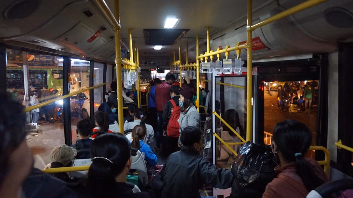 Bên trong xe buýt chật cứng hành khách, hành lý. Các ghế ngồi không còn chỗ trống nên rất nhiều hành khách phải đứng.