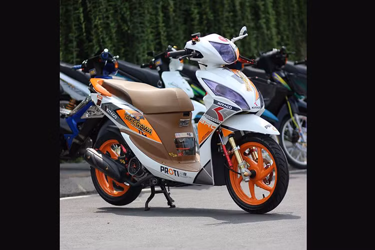 Chiếc xe ga Honda Vision độ này được "lột xác" hoàn toàn, nổi bật với tông màu trắng- cam đậm phong cách Honda Repsol cùng dàn tem được chủ xe độ lại bắt mắt và phong cách hơn so với nguyên bản .