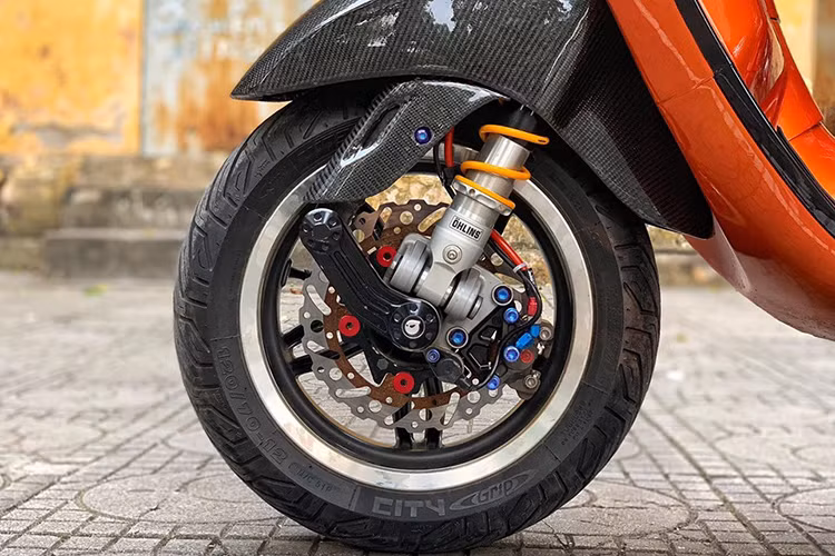 Dàn chân trước của xe là phuộc Ohlins trước được sản xuất dành riêng cho dòng xe ga Vespa sử dụng không cần chế cháo bất kì chi tiết nào, bên cạnh đó là đĩa Braketech và một điểm nhấn quan trọng nhất chính là chú heo dầu Brembo Moto3/125 rear caliper 2 pis đối xứng có giá trị hơn hơn khoảng 15 triệu đồng vô cùng đẹp.