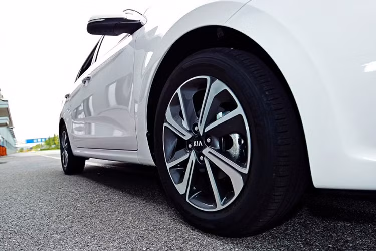 Thân xe Kia Rio sedan 2017 có nhiều đường gân vuông vắn, bớt tròn trịa hơn trước, tay nắm cửa mạ crôm cùng với bộ mâm xe dạng nan 4 cánh kép kích cỡ 16 inch cho cảm giác khá sang trọng.