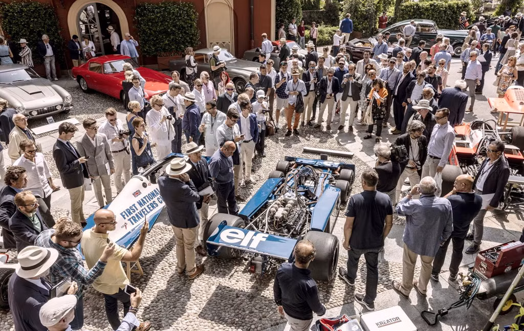Ban giám khảo và khách tham quan vây quanh chiếc xe đua Tyrrell P34 Formula One đời 1977. Vào thời đó, thiết kế 6 bánh rất thông dụng trên đường đua nhưng cũng chỉ là xu hướng nhất thời. Bốn bánh nhỏ phía trước giúp xe bám đường tốt hơn.
