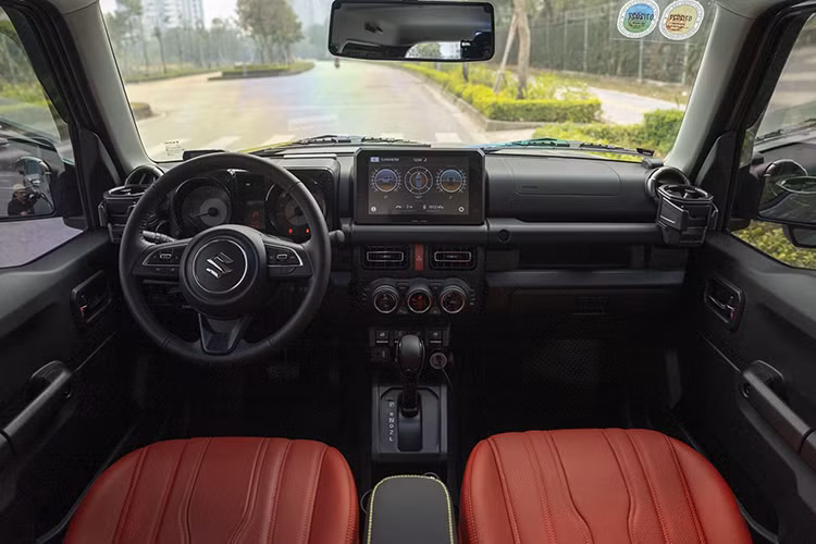 Không chỉ dừng lại ở ngoại thất, nội thất của chiếc Jimny cũng được chăm chút kỹ lưỡng. Toàn bộ ghế nỉ được bọc da Nappa màu đỏ tạo cảm giác sang trọng. Ngoài ra, một giá treo tiện dụng được lắp đặt giúp người dùng dễ dàng mang theo các túi đồ khi cần đi dã ngoại.