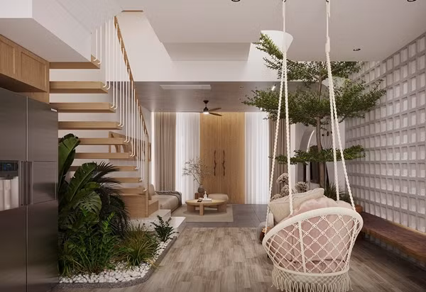 Khoảng trống dưới cầu thang được tận dụng trồng các loại cây, tạo thành góc tiểu cảnh xanh mát. Ảnh: SBS House
