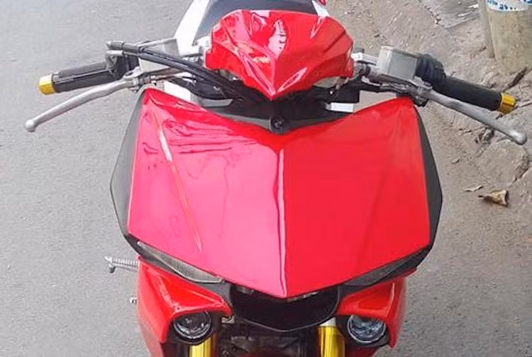 Ở phía trước, toàn bộ dàn đầu của Exciter 150 nguyên bản đã được loại bỏ, thay vào đó là ghi-đông clip-on trần. Ở bên dưới, phần mặt nạ của xe đã được chế mủ lại với thiết kế lấy từ chiếc siêu môtô PKL hàng đầu của Yamaha hiện nay là Yamaha R1.