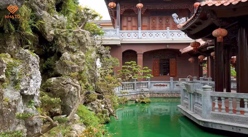Ao cá rộng rãi bao trọn chòi nghỉ với hệ thống núi đá xung quanh.